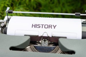 A typewriter loaded with a piece of paper titled "History."
