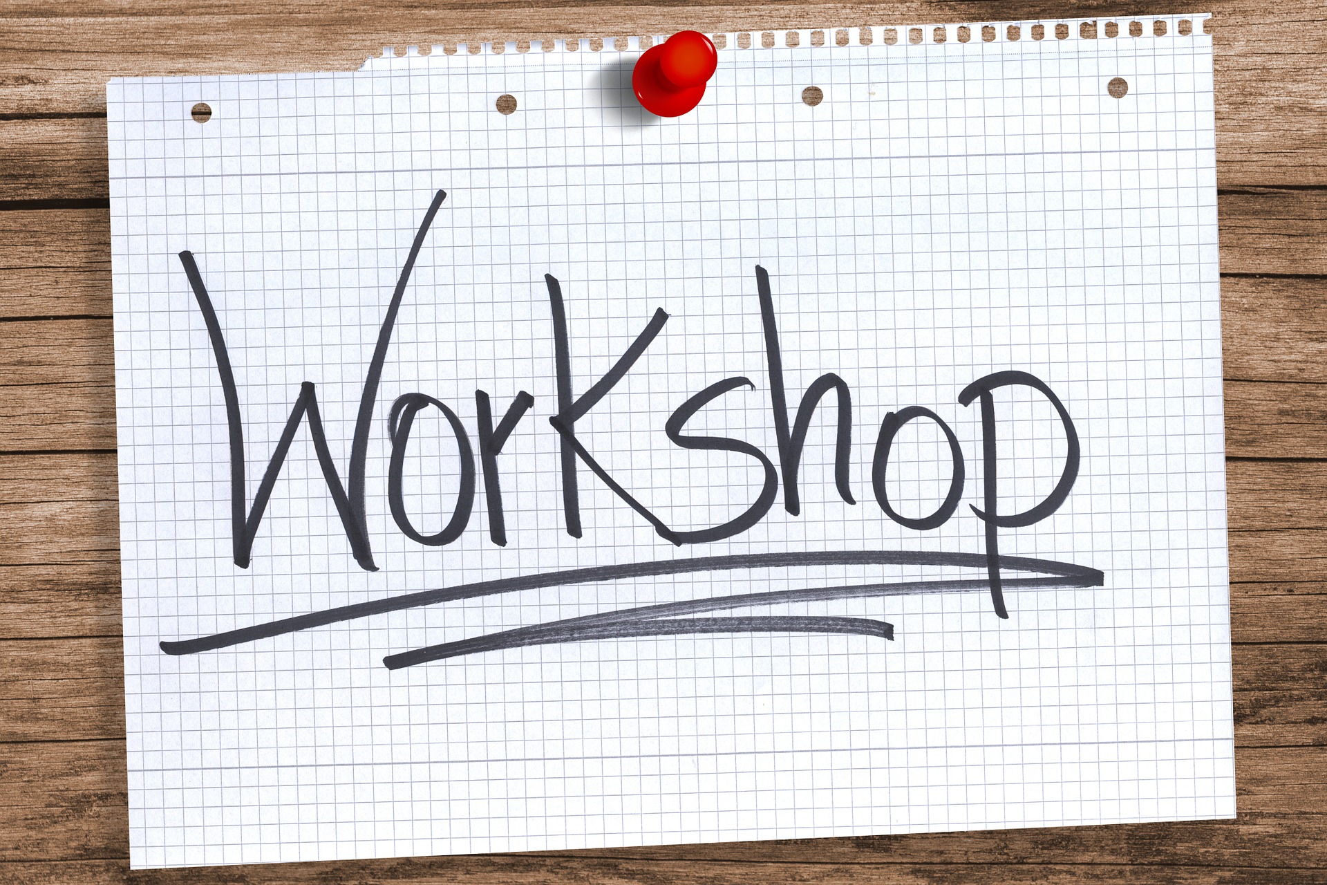 The word "Workshop" written and underlined on a torn piece of paper.