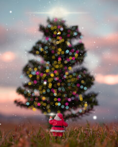 Santa looking up at a large Christmas tree.
