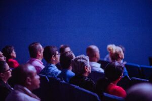 People sitting in an auditorium listening.